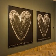 Room at Moco Museum Amsterdam featuring black heart artworks and handwritten quotes by Robbie Williams.